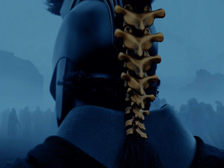 The back of Agamemnon's helmet, decorated with a gold spinal cord. Image cropped from a poster for Christopher Nolan's The Odyssey. © 2026 Universal Pictures