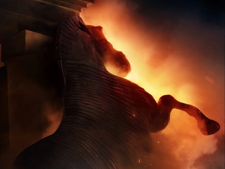 The Trojan Horse from Christopher Nolan's The Odyssey. The giant wooden horse is seemingly aflame. © 2026 Universal Pictures